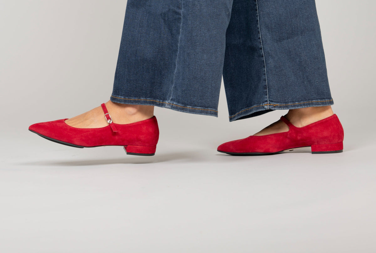 Scarlett Chase Belle Ballet Flat Red Suede with an adjustable Mary-Jane strap | On foot walking on a grey background