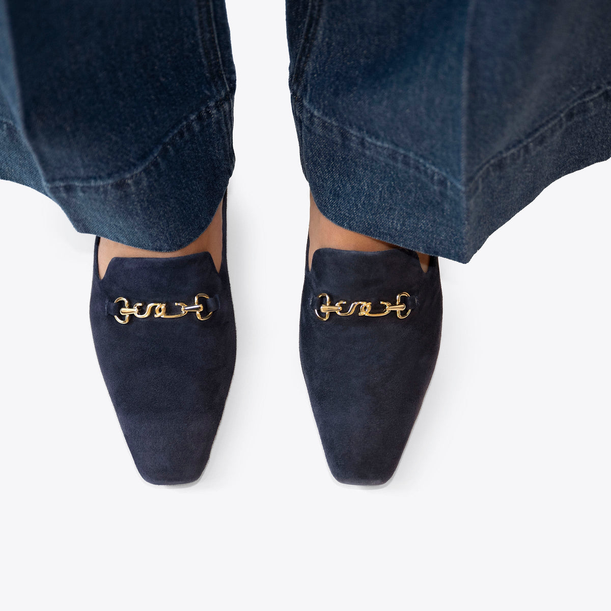 Scarlett Chase navy suede Chase loafer with champagne SC accessory and floral lining | overhead view on feet with navy pants and a white background