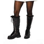 Scarlett Chase Aspen Knee-High Winter Shearling Boot in Black Leather with silver nickel eyelets and a black lace | Woman's legs showing 3/4 front view of boots dressed in black nylons and white short garment