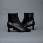 Scarlett Chase ankle zip black napa Aimee 55 bootie with a block heel and gore stretch | Side view of pair facing opposite directions on gray background