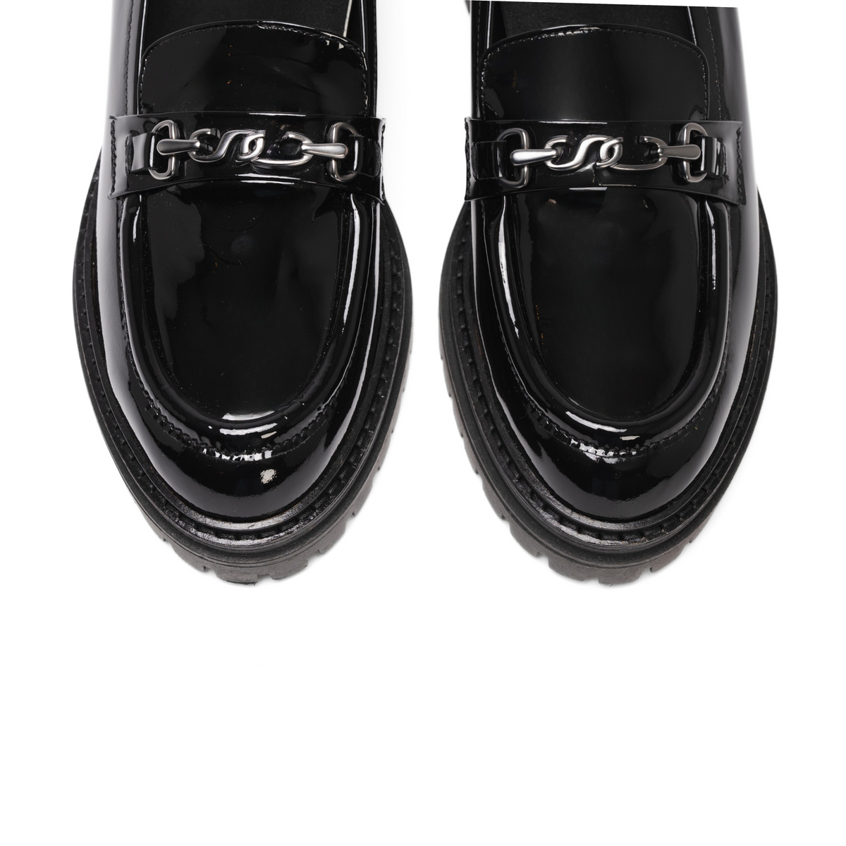 Overhead view of Arden lug loafer showing gunmetal accessory across shoe on white background