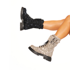 Scarlett Chase Athena Combat Boot with a lightweight sole, functioning hardware, and a hidden zipper | Person wearing one Nylon Black Camouflage boot and one beige camouflage  side view on white background
