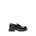 Scarlett Chase Ava Lug Penny Loafer in Black Leather with a lightweight sole and SC coin | side view, white background