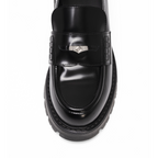 Scarlett Chase Ava Lug Penny Loafer in Black Leather with a lightweight sole and SC coin | overhead view, white background