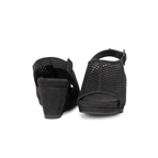 Scarlett Chase Chelsea Wedge Sandal with a perforated leather upper and adjustable back strap | A pair of black wedge sandals with perforated cutout straps, shown from the back and front angles on a white background.