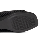 Scarlett Chase Chelsea Wedge Sandal with a perforated leather upper and adjustable back strap | Close-up of the black textured sole and mesh upper of sandal on a white background.