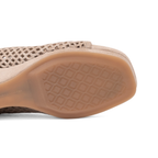 Scarlett Chase Chelsea Wedge Sandal with a perforated leather upper and adjustable back strap | Close-up of the outsole of sandal, showing a textured geometric diamond pattern on a white background.