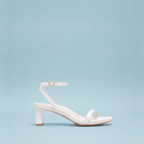 Scarlett Chase white satin Coco 45 dress sandal with minimalist straps and an adjustable backstrap | Profile on light blue backdrop