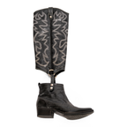 Scarlett Chase black leather Fiona cowboy bootie with decorative stitching and a side zipper and interchangeable knee-high gaiter with decorative sticking and clip-on straps| Profile of knee-high gaiter detached from bootie on white background