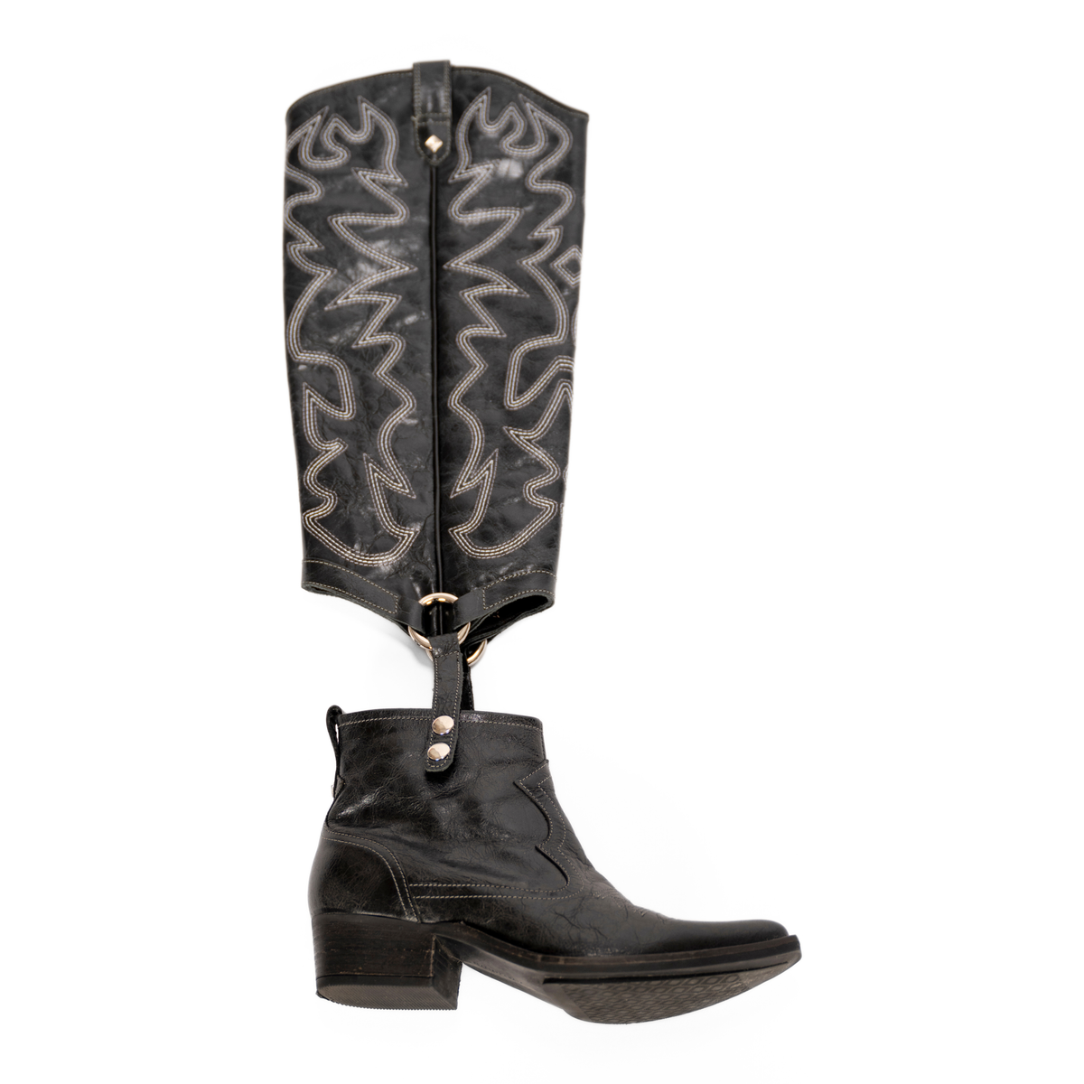 Scarlett Chase black leather Fiona cowboy bootie with decorative stitching and a side zipper and interchangeable knee-high gaiter with decorative sticking and clip-on straps| Profile of knee-high gaiter detached from bootie on white background