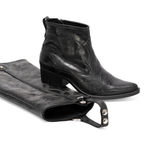 Scarlett Chase black leather Fiona cowboy bootie with decorative stitching and a side zipper and interchangeable knee-high gaiter with decorative stitching and clip-on straps | 3/4 view of bootie resting on gaiter on white background
