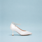 Scarlett Chase Serena 75 Bridal Pump in white satin with a pearl rhinestone removable and adjustable ankle strap | Profile on sky blue background