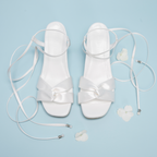 Scarlett Chase Cali 45 white satin dress sandal with wrap-around ties and a gathered front | Overhead view on blue background