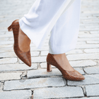 Scarlett Chase Sumatra croc embossed leather Amore 55 Pump with a rounded upper and block heel | Side view of pair on feet walking back foot off ground outside on stone walkway