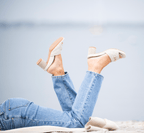 Scarlett Chase Chloe panna cotta napa leather 45 raffia block heel sandal with a mesh-lined quilted upper and SC accessory | Model outside on beach shoes in air outsole and 3/4 view 