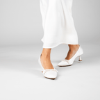 Scarlett Chase Gloria 55 White Satin Pump with a rounded upper, minimalist satin bow, and a sculpted heel | on model 3/4 view of each different directions on white background