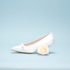 Scarlett Chase Gloria 55 White Satin Pump with a rounded upper, minimalist satin bow, and a sculpted heel | Profile on light blue background 