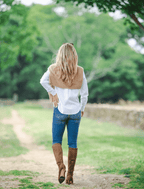 Scarlett Chase knee-high stretch chocolate suede Lola 75 boot with a block heel | On model on grass outside walking back view left heel in air outsole view 