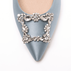 Scarlett Chase Paris rhinestone clip-on brooch shoe accessory and blue satin Roma 55 Slingback with a stable, sculpted heel and an adjustable backstrap buckle |   brooch on shoe toe detail on white background