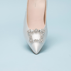 Scarlett Chase Paris rhinestone clip-on brooch shoe accessory | top down on light blue background on white satin shoe