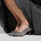 Scarlett Chase Soiree 75 Pump Gray Python with a V-cut upper and sculpted heel | Model wearing pumps while squatting down