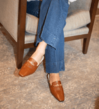 Scarlett Chase Weston Mule in Caramel Napa with floral lining and an SC gold accessory | Overhead view on feet on carpet