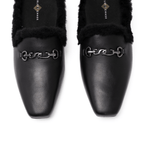 Scarlett Chase Weston Black Leather and Black Shearling Mule with an SC accessory | Overhead view on a white background
