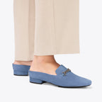 Scarlett Chase Weston Mule in Sky Blue Suede with floral lining and an SC silver accessory | On feet on white background