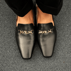 Scarlett Chase Weston Mule in Black Napa with floral lining and an SC gold accessory | Overhead view on feet on granite floor 