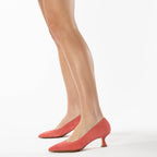 Scarlett Chase coral suede Gala 55 Pump with a rounded upper and sculpted heel | Profile on model bare legs facing left on white background