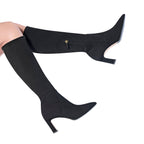 Scarlett Chase knee-high black stretch suede Lola 75 boot with a block heel and a zipper | On model bare legs in air staggered side view on white background