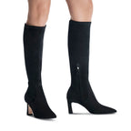 Scarlett Chase knee-high black stretch suede Lola 75 boot with a block heel and a zipper | On model bare legs staggered 3/4 view on white background